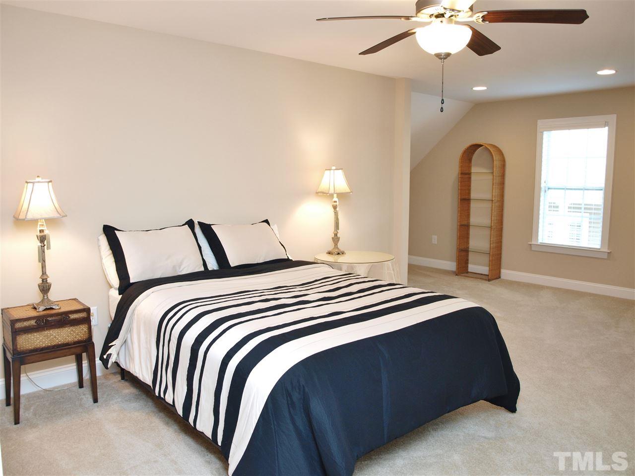 300 Bon Marche Lane Raleigh, NC 27615 - Photo 16 of 25 a bedroom with a bed and a chandelier