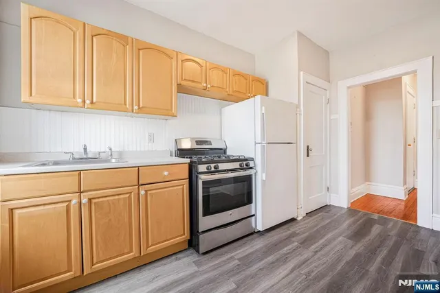 a kitchen with stainless steel appliances granite countertop a stove and a sink