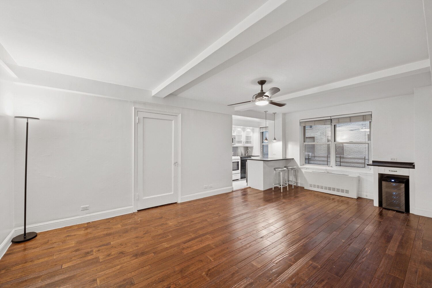 424 East 52nd Street, Unit 2D Manhattan, NY 10022 - Photo 4 of 17 a view of an empty room with window and wooden floor