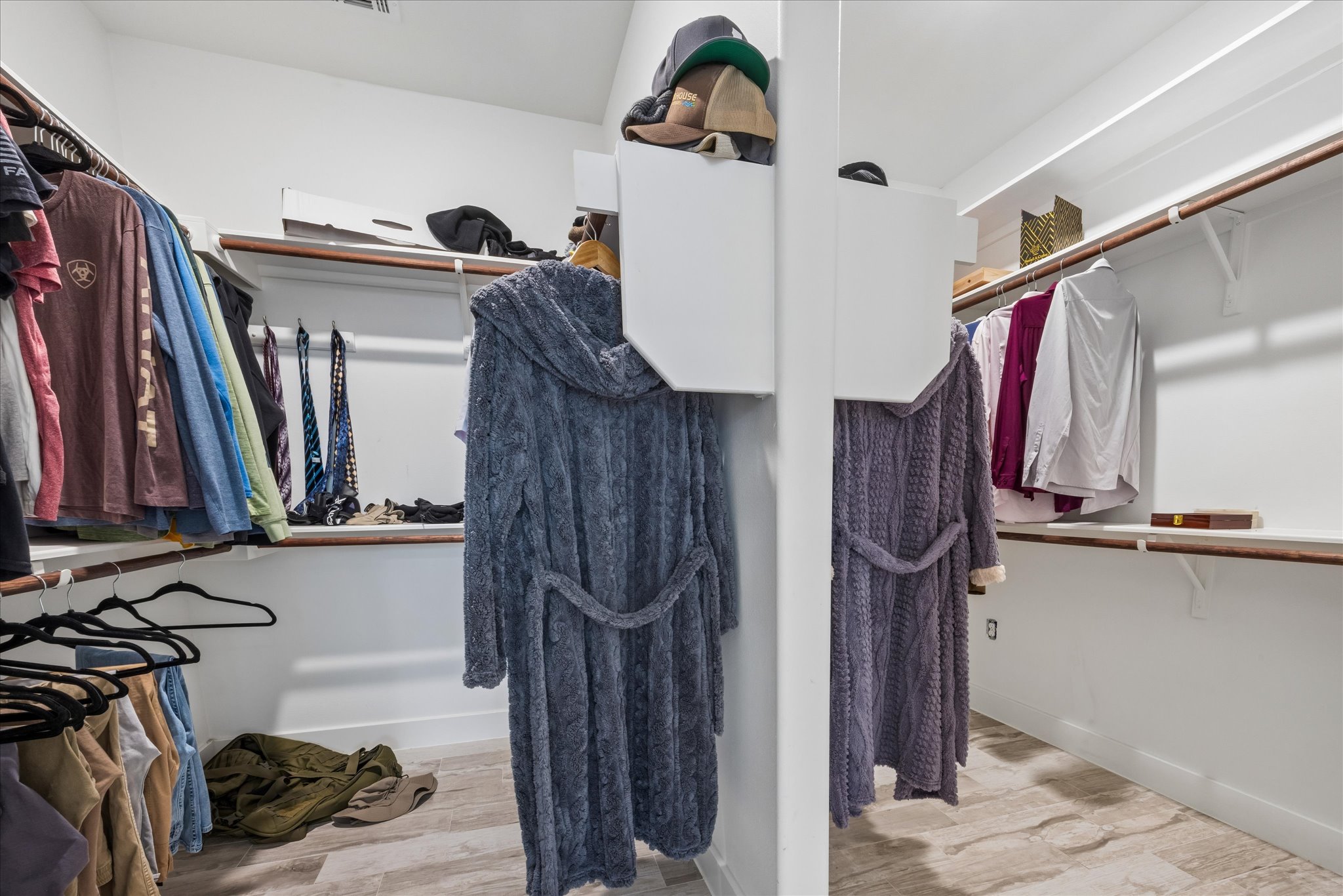 116 Mallard Road Bastrop, TX 78602 - Photo 14 of 31 Ample built-in shelving and hanging rods organize this functional walk-in closet space.