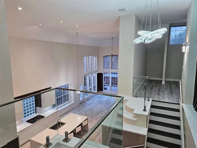 a view of entryway and hall with wooden floor