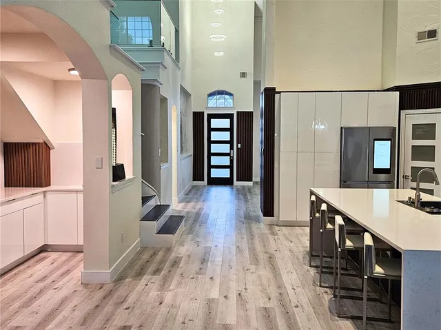 a view of a hallway with wooden floor windows and livingroom
