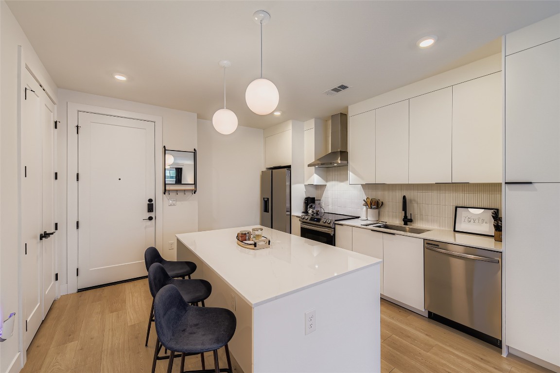a kitchen that has a cabinets a sink and appliances