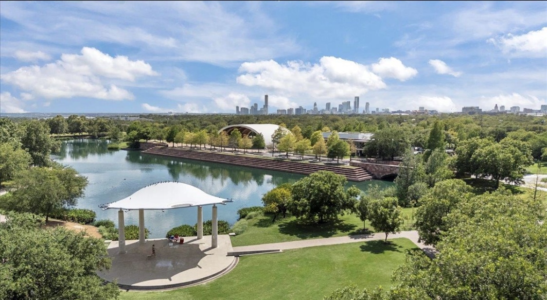 1701 Simond Avenue, Unit 513 Austin, TX 78723 - Photo 13 of 27 a view of a swimming pool with a table and chairs under an umbrella