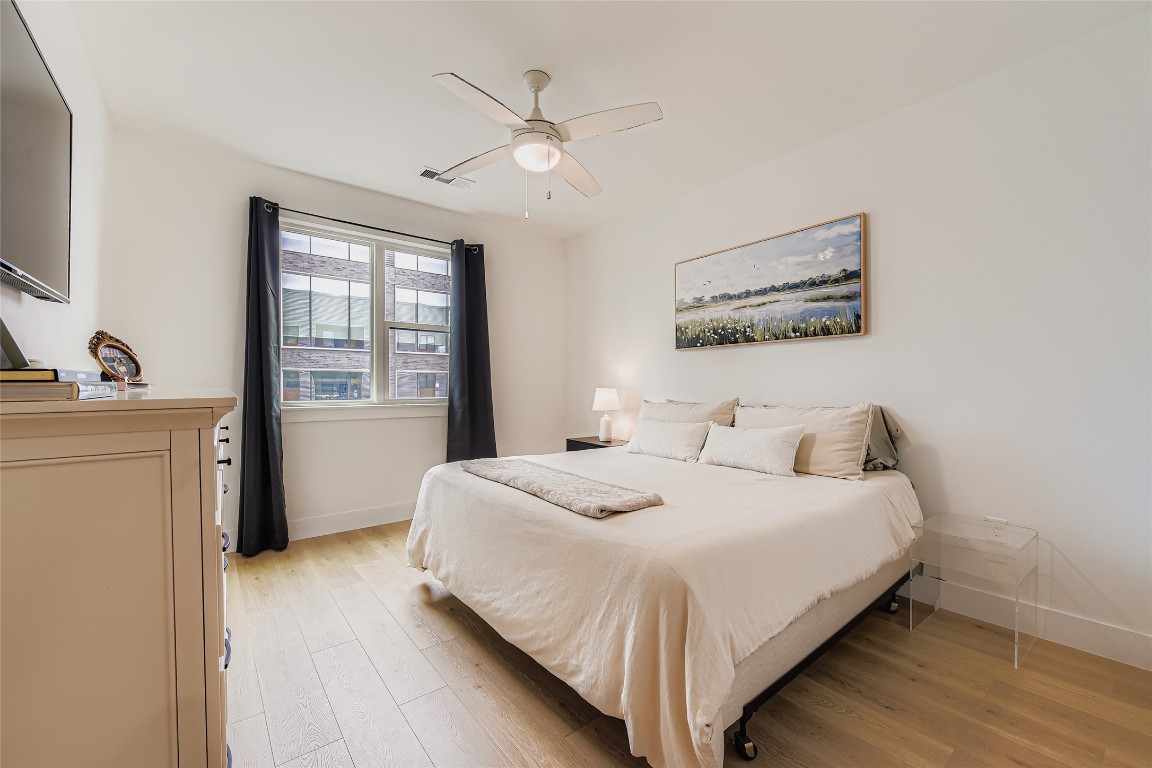 1701 Simond Avenue, Unit 513 Austin, TX 78723 - Photo 7 of 27 a bedroom with a bed and a table