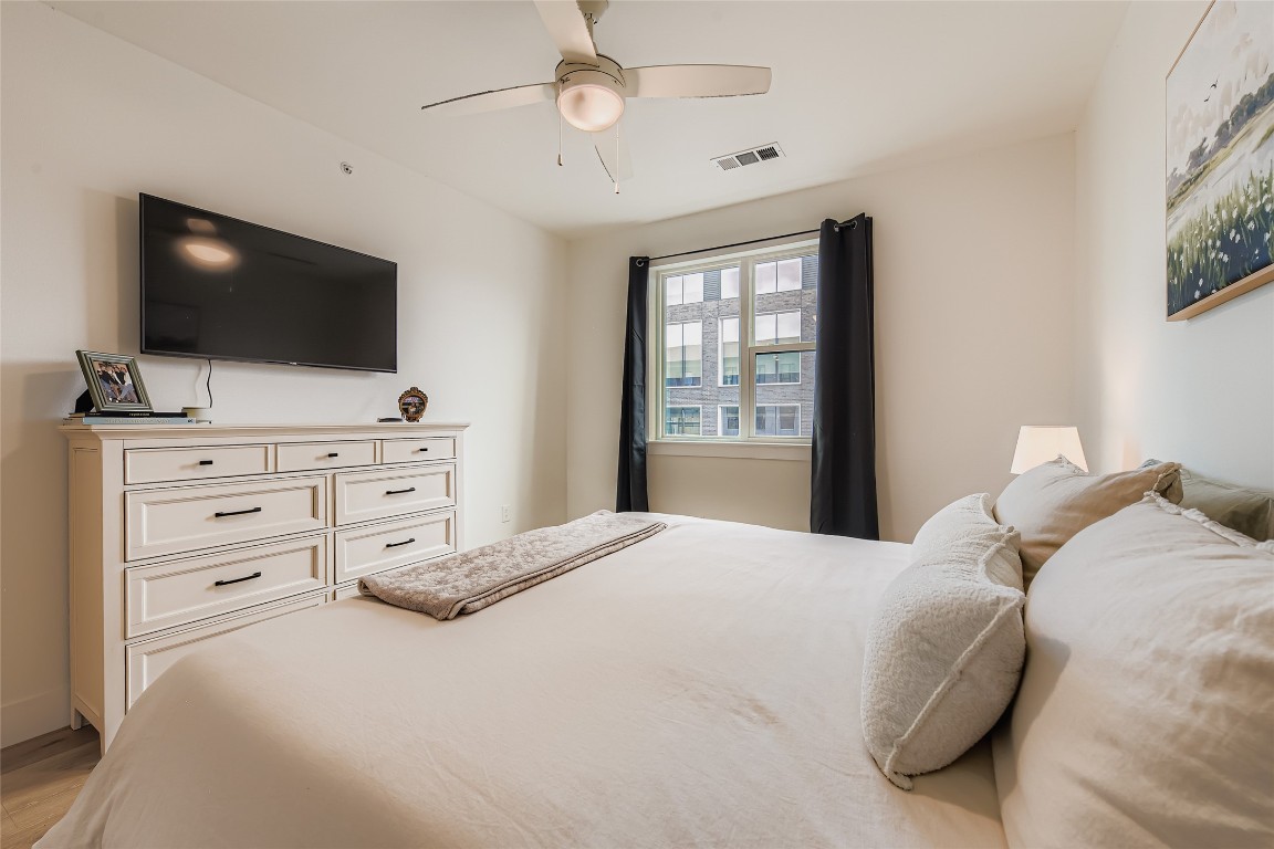 1701 Simond Avenue, Unit 513 Austin, TX 78723 - Photo 8 of 27 a bedroom with a large bed and flat screen tv