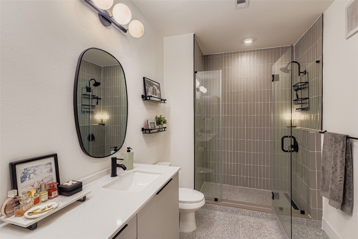 1701 Simond Avenue, Unit 513 Austin, TX 78723 - Photo 9 of 27 a bathroom with a sink a toilet and shower