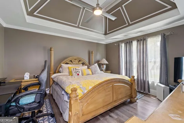 a bedroom with a bed and a tv