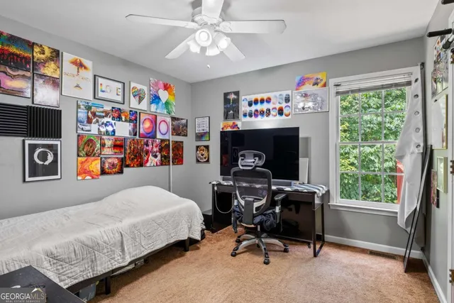 a bedroom that has a bed and a table in it