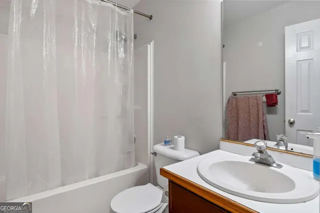 a bathroom with a sink toilet and a mirror