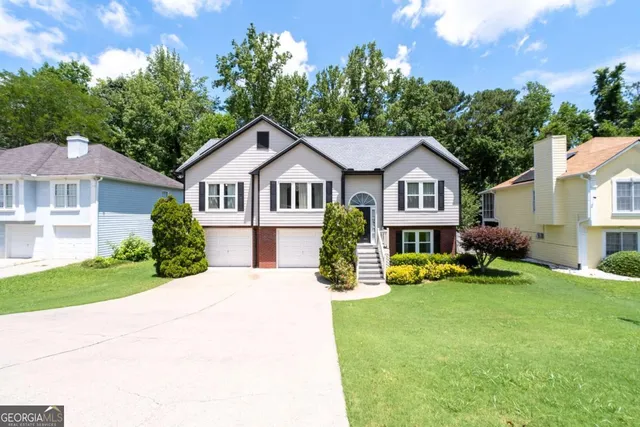 a front view of a house with a yard table and chairs