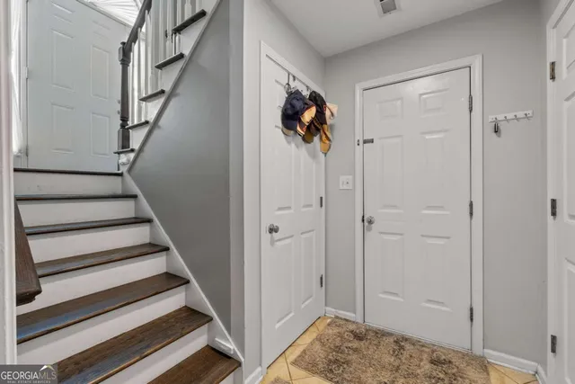 a view of a hallway with wooden floor and entryway