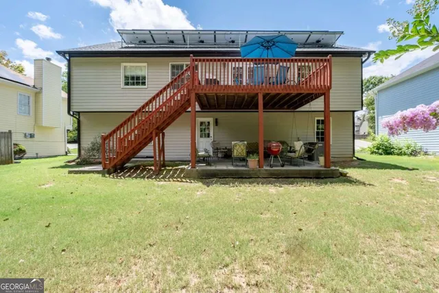 a view of a house with swimming pool and sitting area