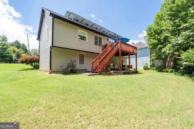 a front view of house with a garden