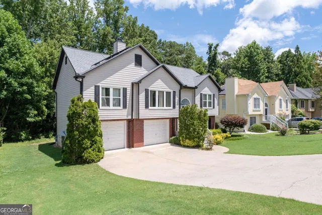 a front view of a house with a garden