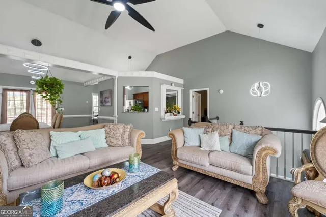 a living room with furniture and wooden floor