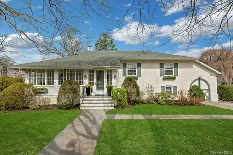 a front view of a house with garden and porch