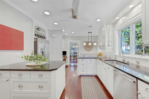 a kitchen with sink stove and refrigerator