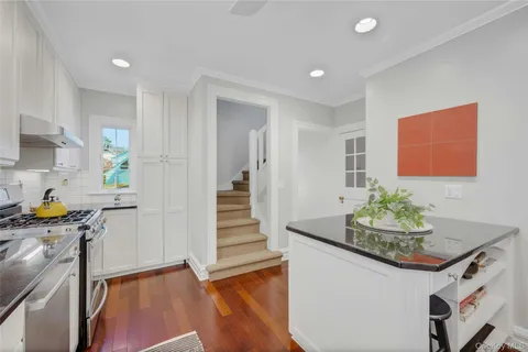 a kitchen with stainless steel appliances granite countertop a stove a sink and a refrigerator
