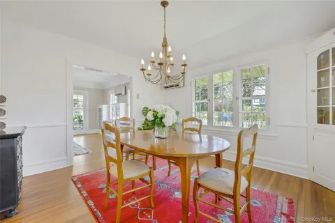 a view of a dining room with furniture and a chandelier