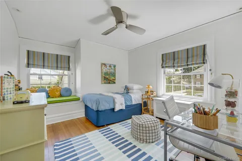 a bedroom with furniture and a large window
