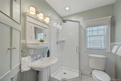 a bathroom with a sink toilet and shower
