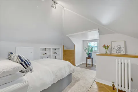 a bedroom with a bed and a dresser in it