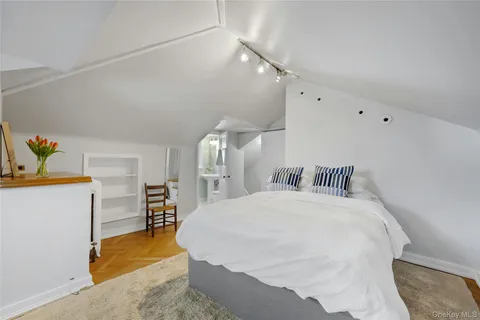 a bedroom with a bed and a dresser in it