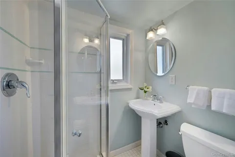 a bathroom with a sink mirror and toilet
