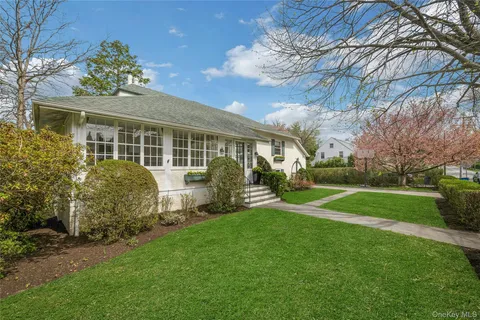 a view of a house with backyard sitting area and garden