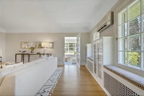 a view of a bedroom with wooden floor and windows