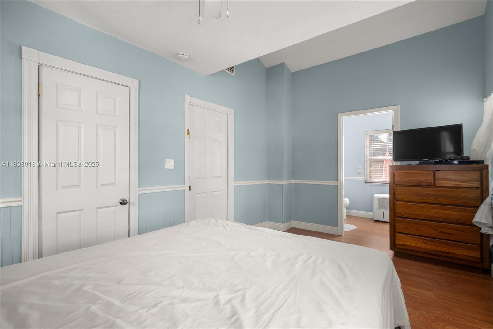 1612 Hitakee Avenue Sebring, FL 33870 - Photo 18 of 34 a bedroom with a bed and wooden floor