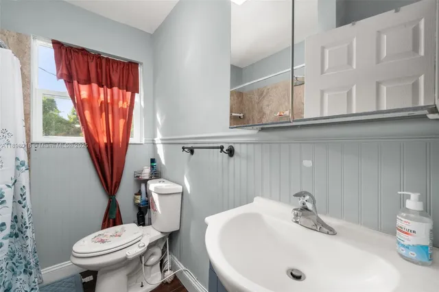 a bathroom with a sink a toilet and tub