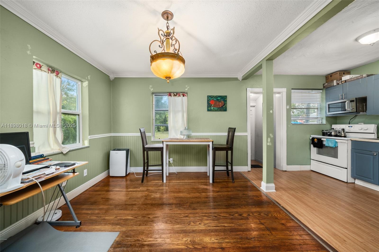 1612 Hitakee Avenue Sebring, FL 33870 - Photo 9 of 34 a living room with furniture a dining table and a fireplace