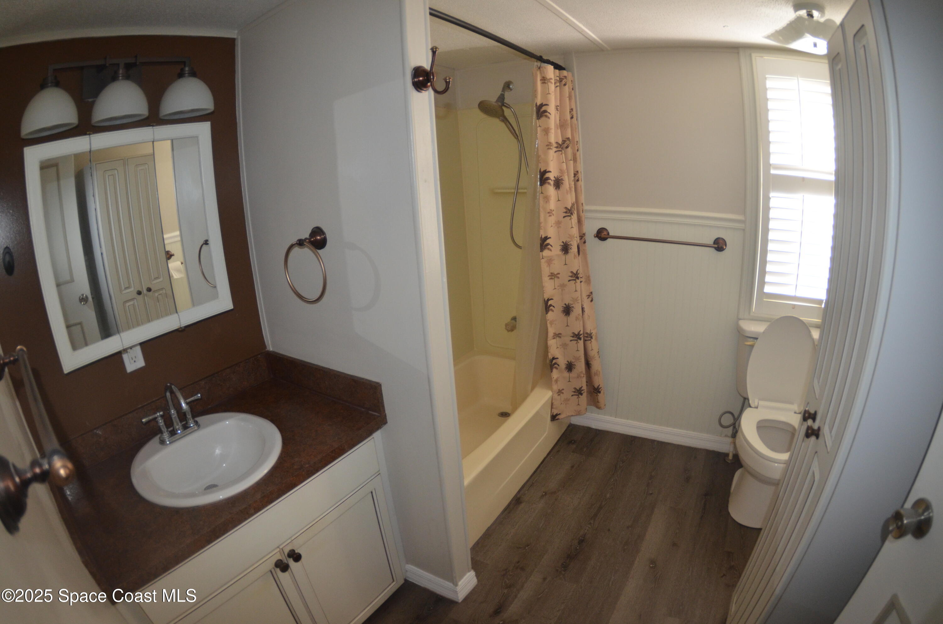 2535 Haverhill Road Northeast Palm Bay, FL 32905 - Photo 12 of 18 a bathroom with a sink a toilet and shower