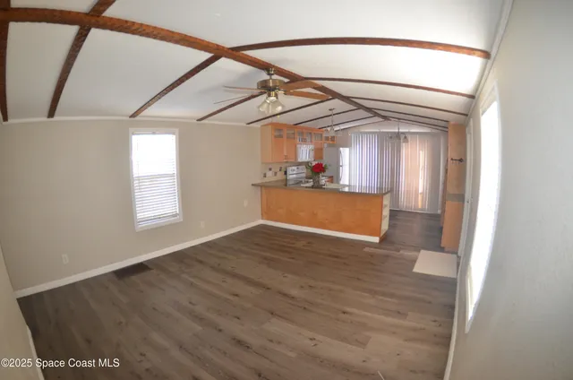 a kitchen with stainless steel appliances granite countertop a sink a stove and refrigerator