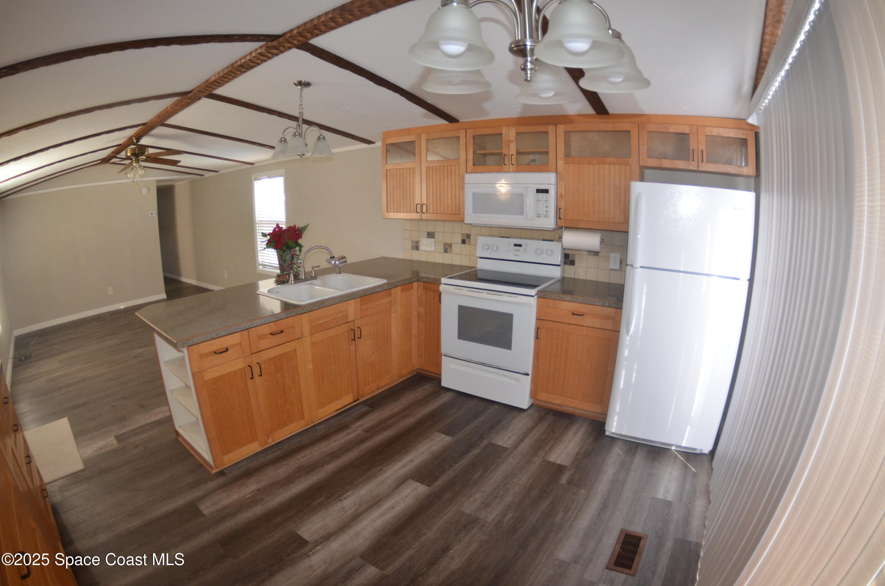 2535 Haverhill Road Northeast Palm Bay, FL 32905 - Photo 7 of 18 a kitchen with stainless steel appliances granite countertop a sink a stove and refrigerator