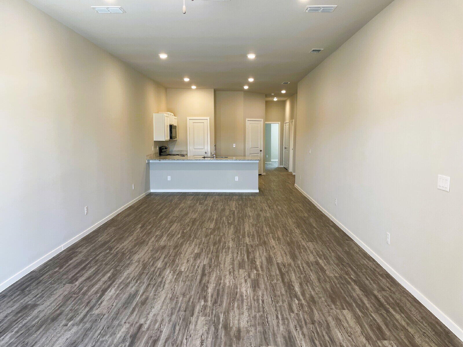 1915 Langford Avenue, Unit A Lubbock, TX 79407 - Photo 13 of 23 a view of a hallway with wooden floor