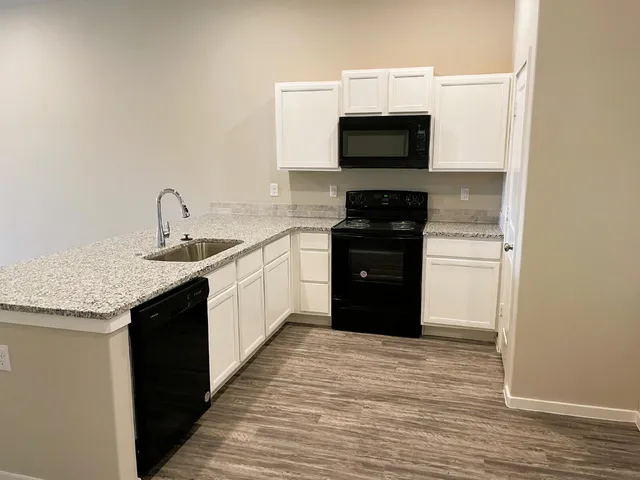 a kitchen with a sink and a microwave