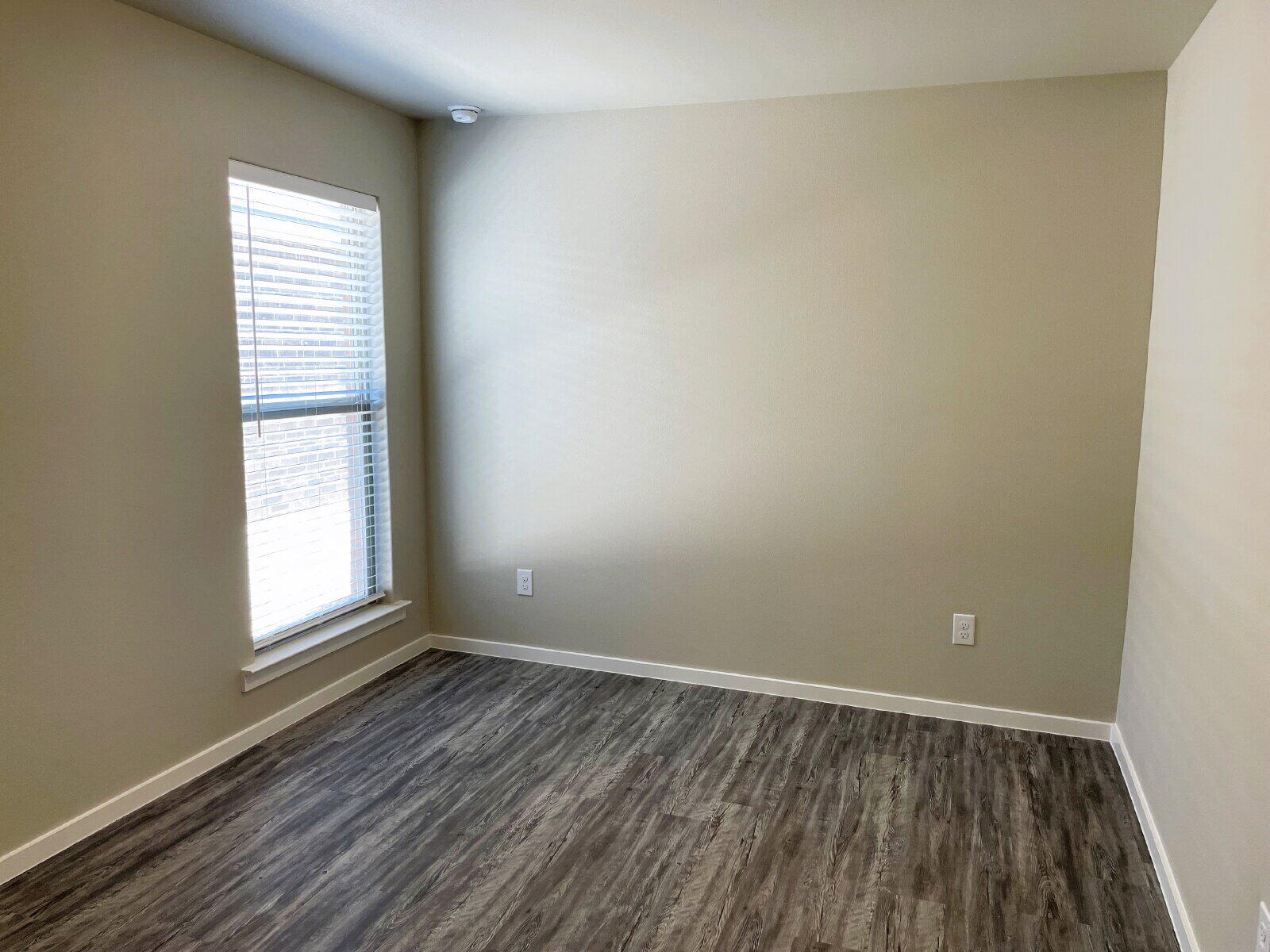 1915 Langford Avenue, Unit A Lubbock, TX 79407 - Photo 17 of 23 an empty room with wooden floor and windows