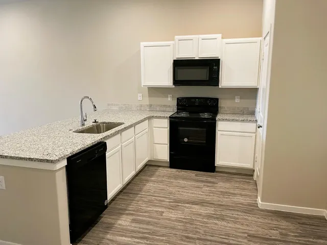 a kitchen with a sink and a microwave