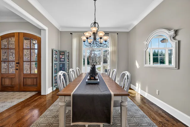 a kitchen with granite countertop white cabinets and stainless steel appliances