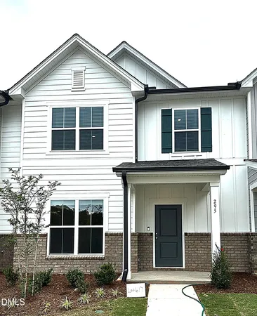a view of a house with large windows and a yard