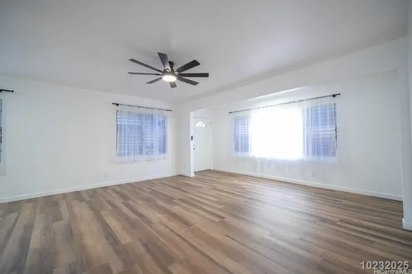 a view of a kitchen with wooden floor and a sink