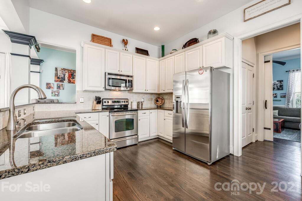 712 Bath Court Fort Mill, SC 29708 - Photo 11 of 42 a kitchen with granite countertop a refrigerator stove and sink