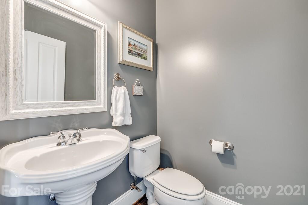 712 Bath Court Fort Mill, SC 29708 - Photo 8 of 42 a bathroom with a sink a toilet and a mirror