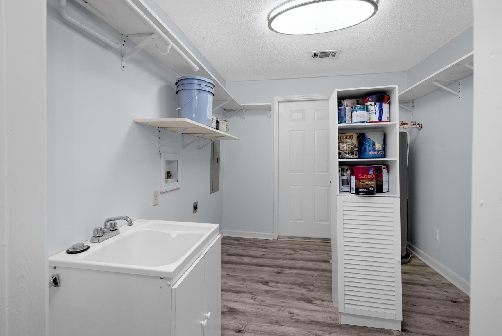 5364 Virgil Road Bartlett, TN 38134 - Photo 15 of 32 Washroom featuring hookup for a washing machine, a textured ceiling, light wood-type flooring, hookup for an electric dryer, and electric panel