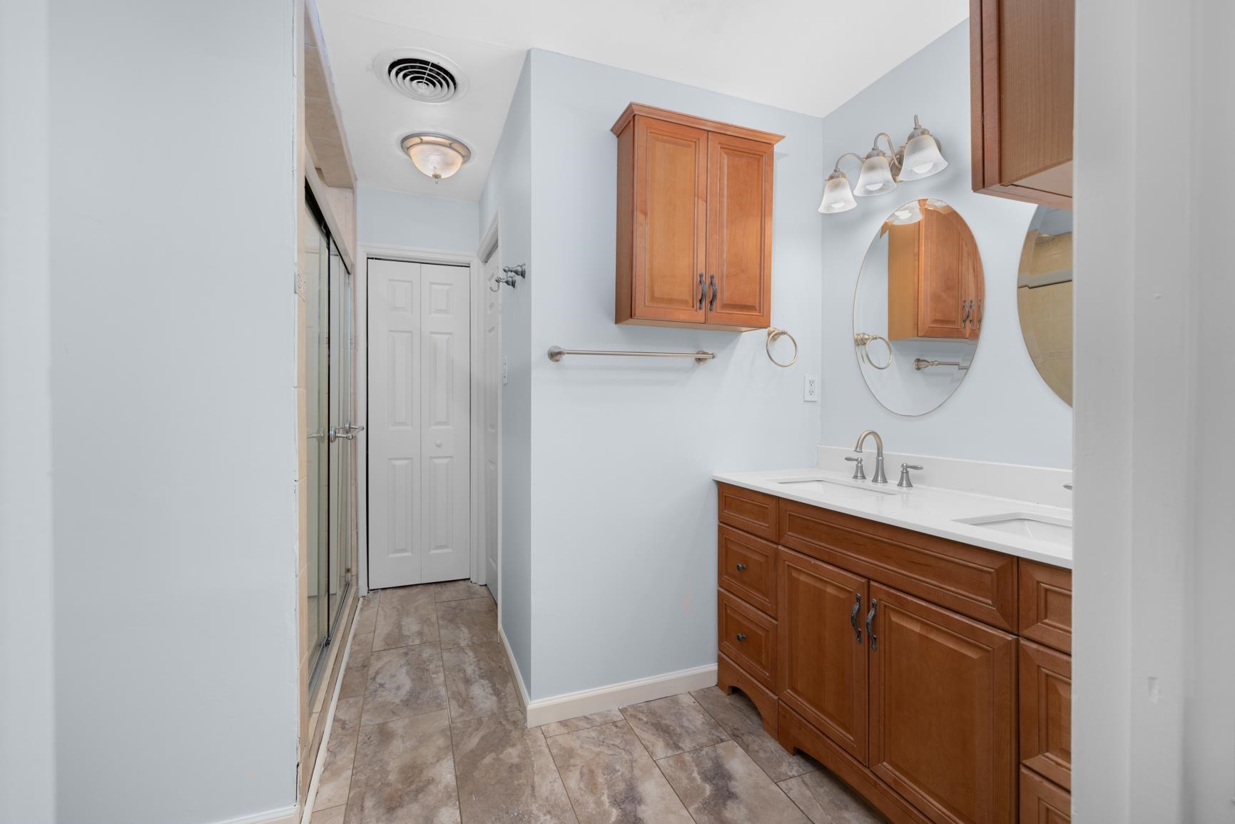 5364 Virgil Road Bartlett, TN 38134 - Photo 20 of 32 Bathroom featuring double vanity, a shower with door, and a closet