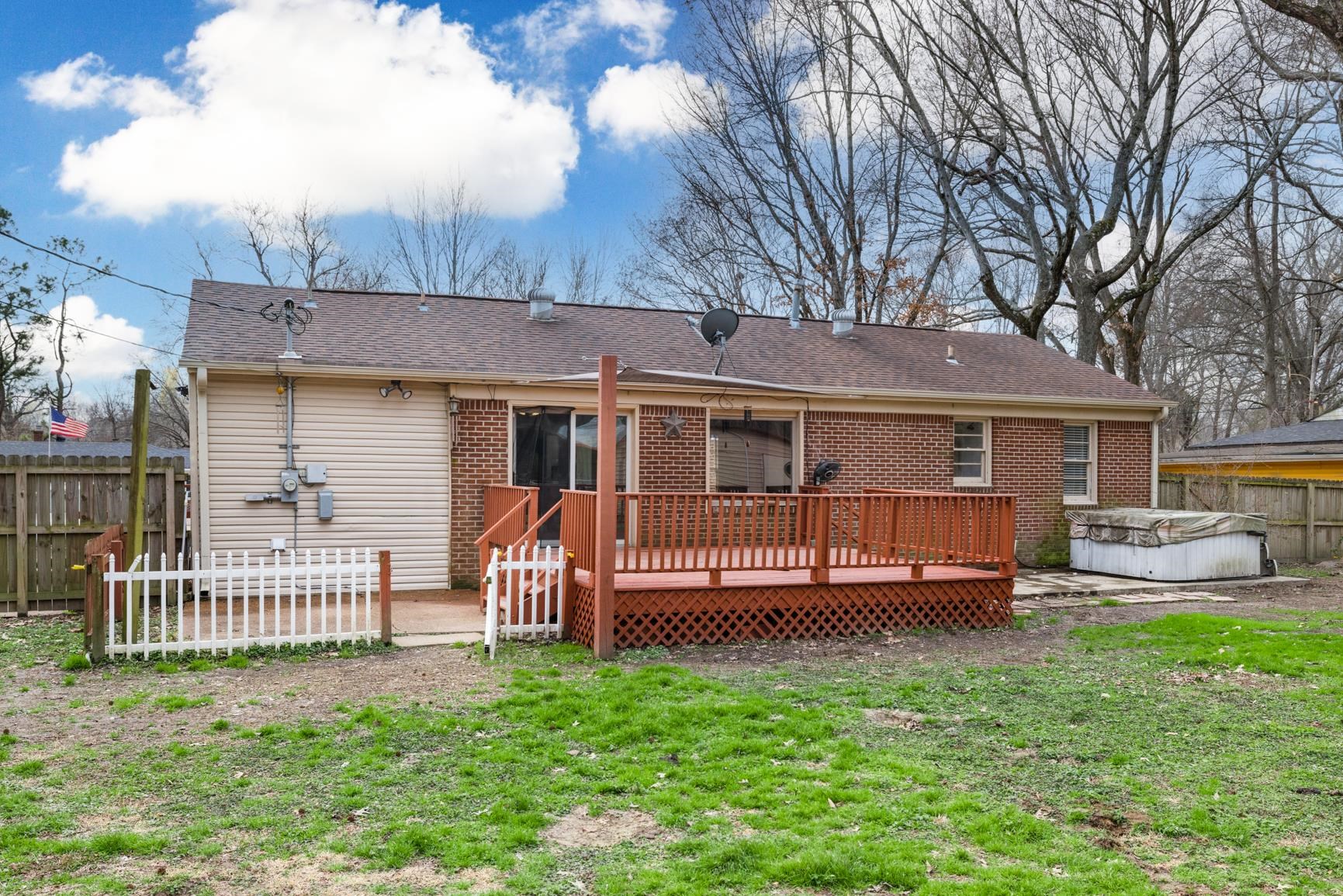 5364 Virgil Road Bartlett, TN 38134 - Photo 29 of 32 Rear view of property featuring a hot tub, a wooden deck, a shingled roof, and brick siding