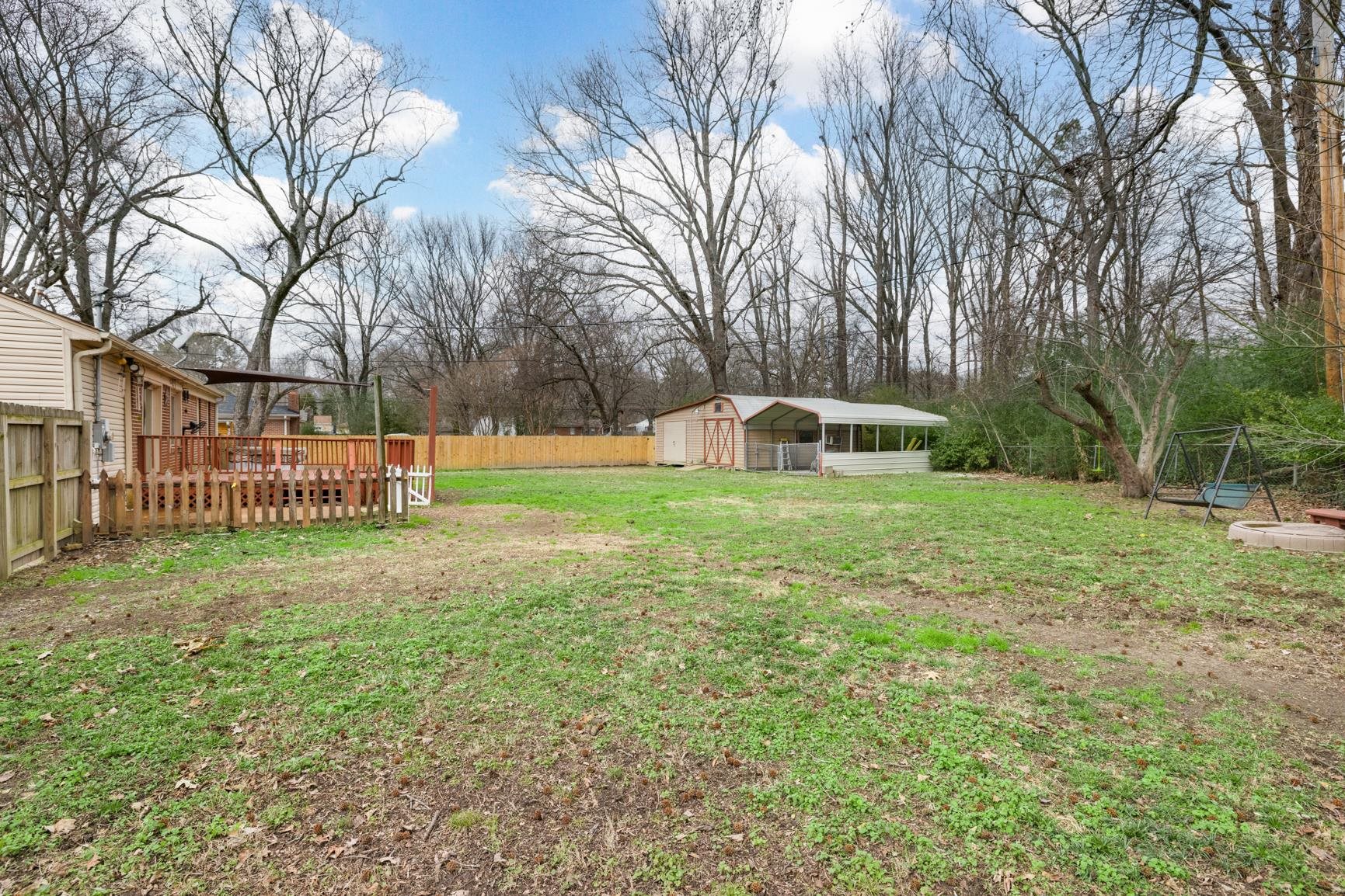 5364 Virgil Road Bartlett, TN 38134 - Photo 32 of 32 Fenced backyard featuring an outdoor structure and a carport